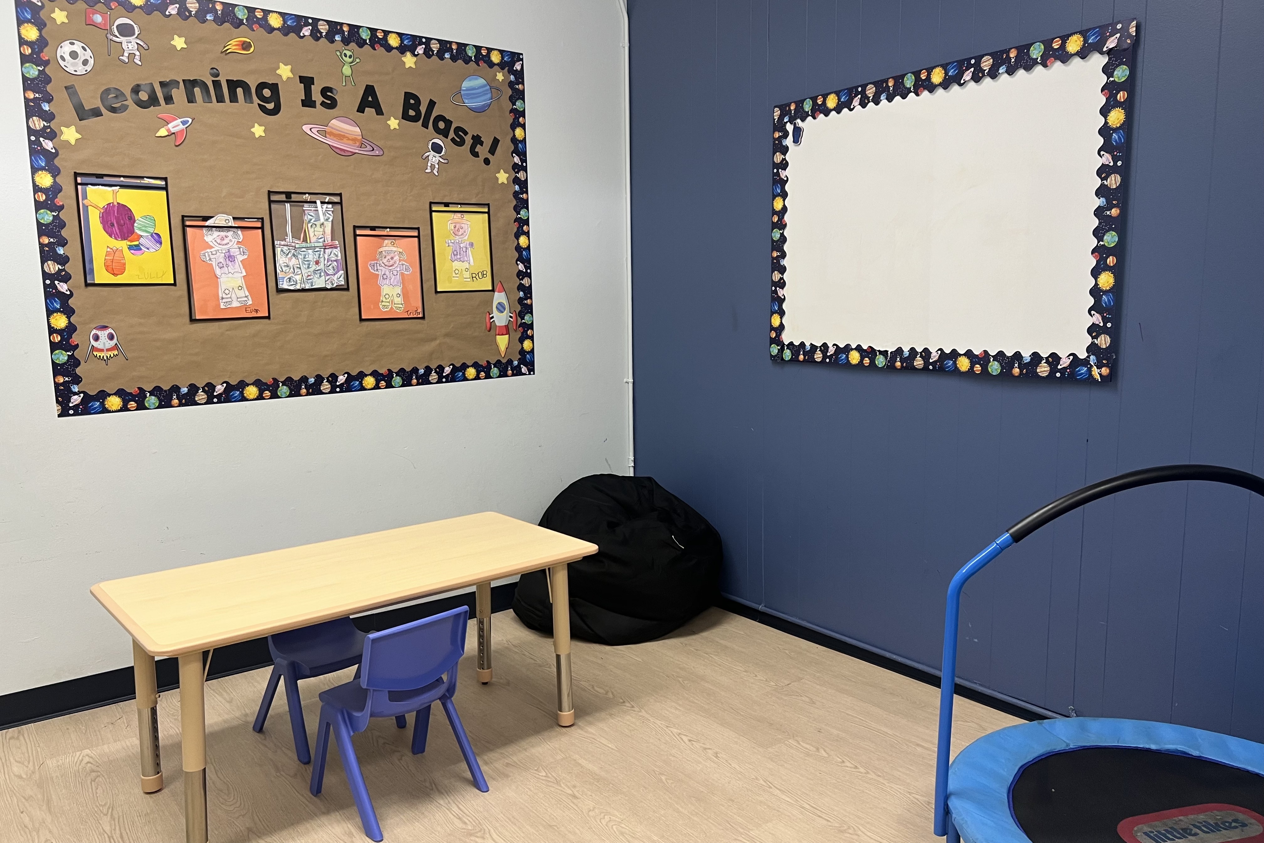 Long Beach ABA Therapy Clinic Room with a bean bag, table, chairs, and artwork on the walls.